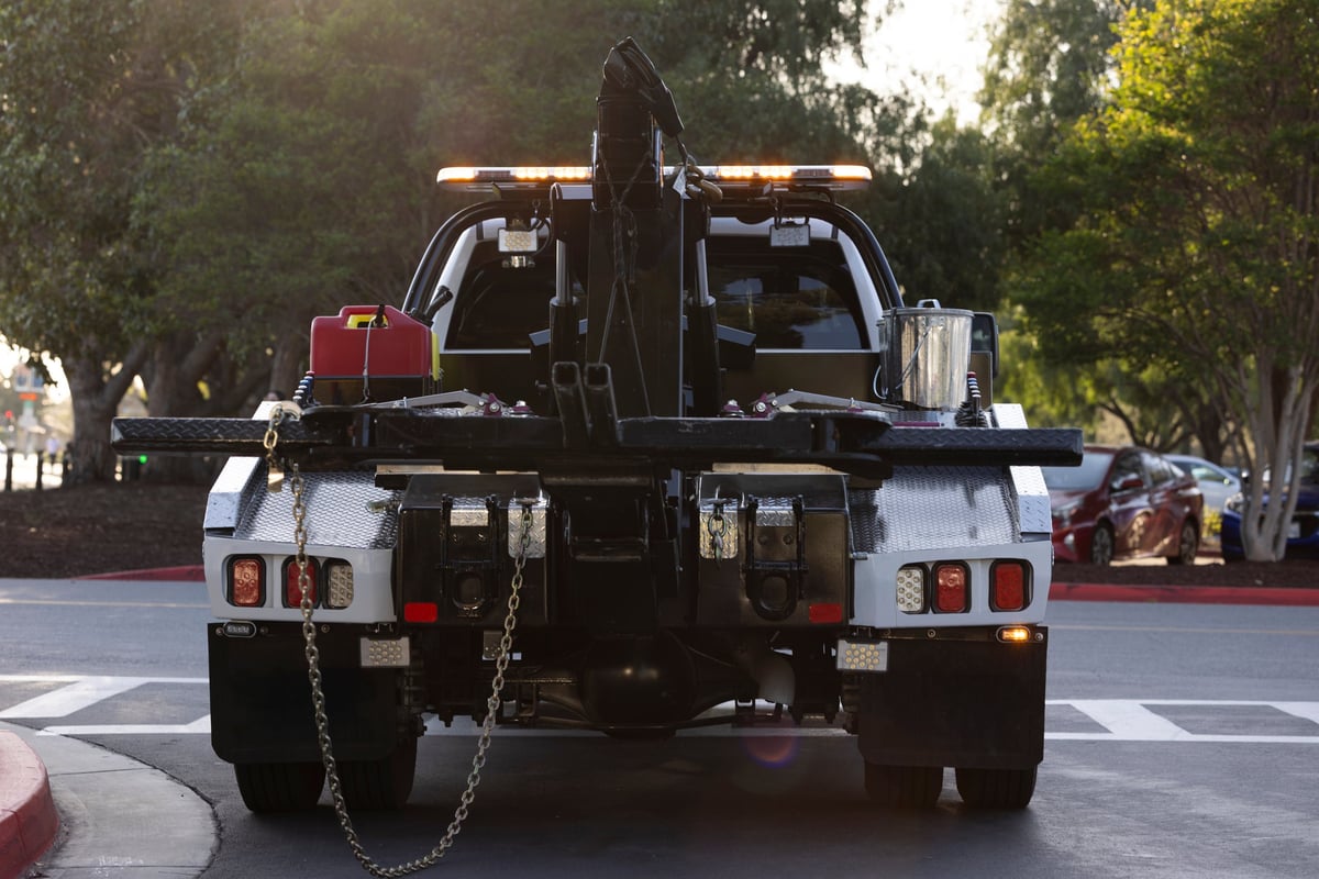 Tow truck at sunset on the road