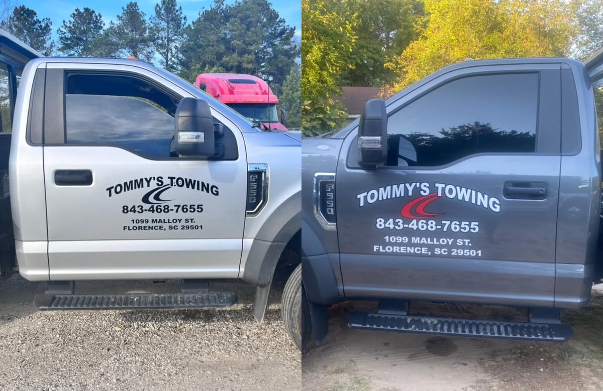 Two Tommy's Towing service trucks parked side by side
